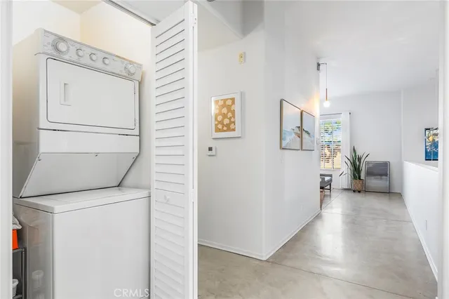 a bedroom with a bed and large windows