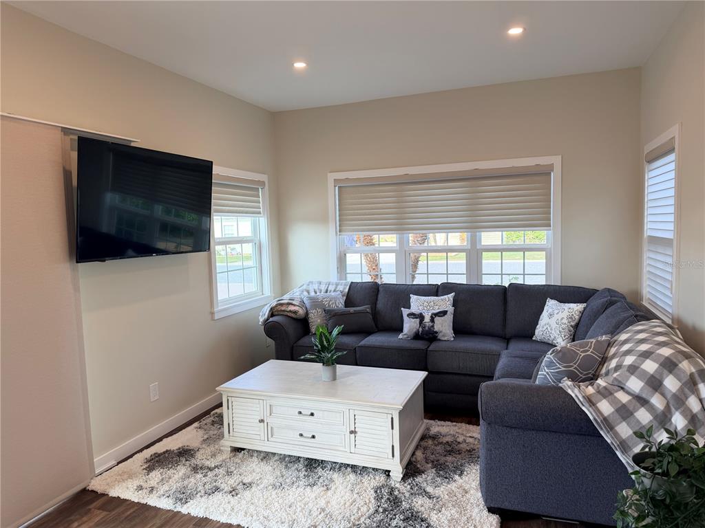 9465 Southeast 47th Way Webster, FL 33597 - Photo 11 of 32 a living room with furniture and a flat screen tv