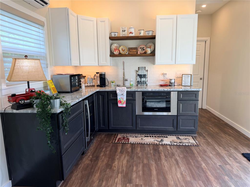 9465 Southeast 47th Way Webster, FL 33597 - Photo 14 of 32 a kitchen with stainless steel appliances granite countertop a stove and cabinets