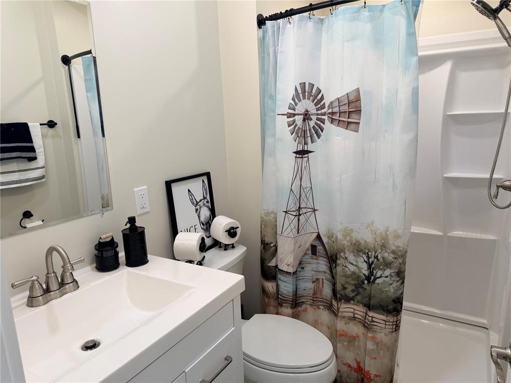 9465 Southeast 47th Way Webster, FL 33597 - Photo 16 of 32 a bathroom with a sink a toilet and a mirror