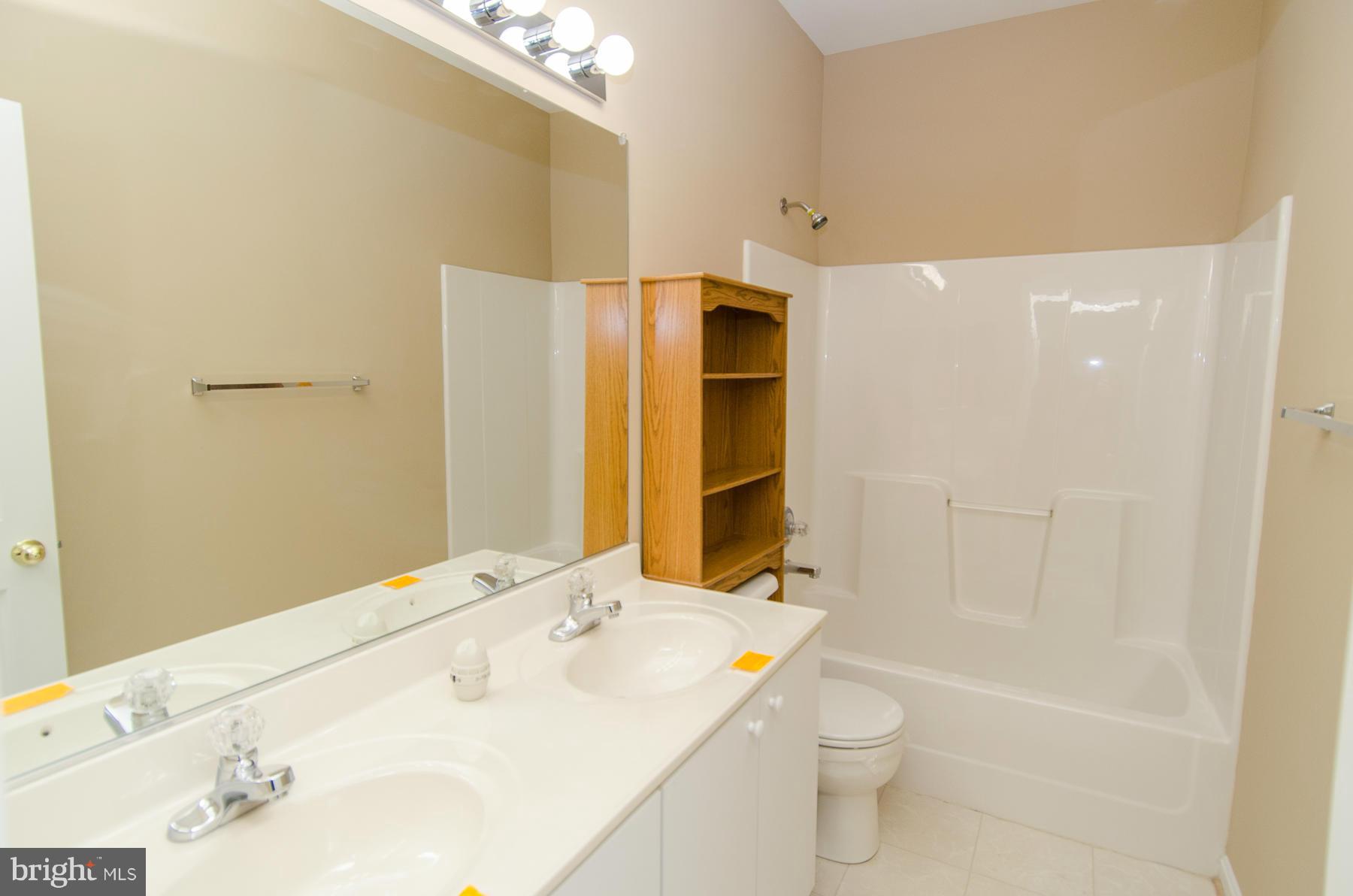 4034 Cutty Sark Road Baltimore, MD 21220 - Photo 15 of 30 a bathroom with a sink a toilet and shower
