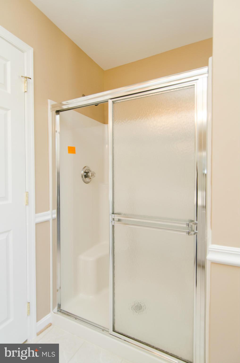 4034 Cutty Sark Road Baltimore, MD 21220 - Photo 23 of 30 a bathroom with a glass shower door