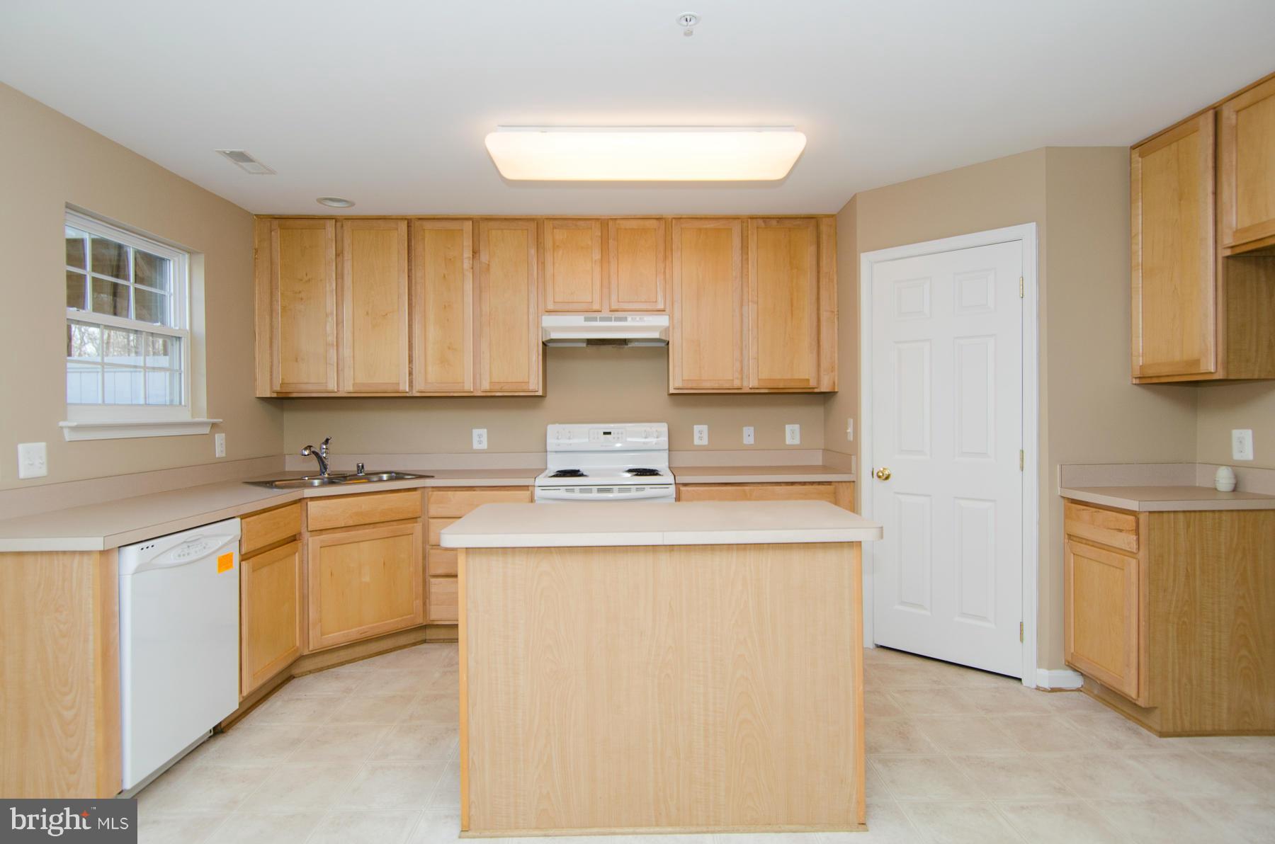 4034 Cutty Sark Road Baltimore, MD 21220 - Photo 7 of 30 a kitchen with stainless steel appliances a stove a sink and a refrigerator