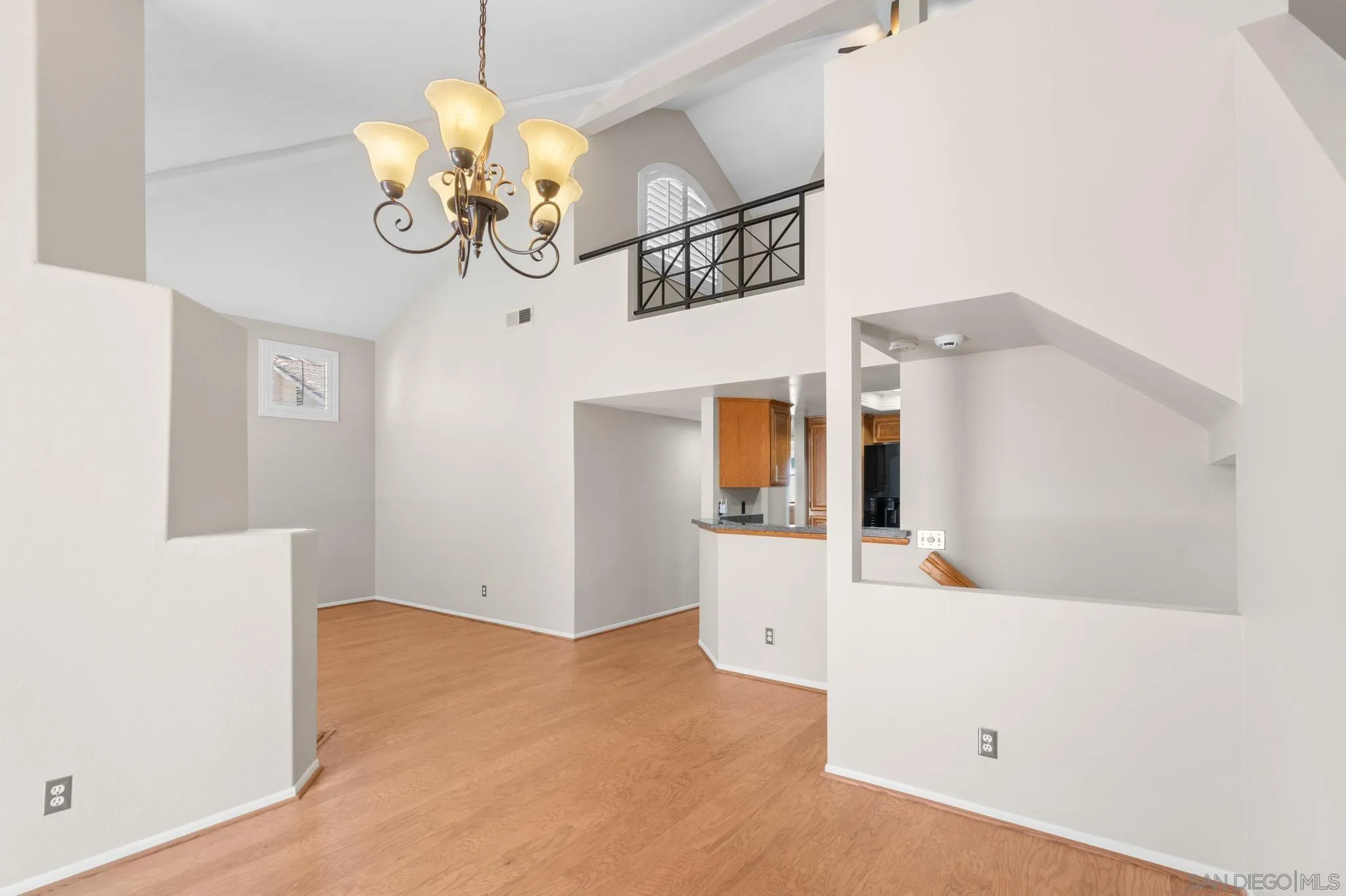 9338 Babauta Road, Unit 78 San Diego, CA 92129 - Photo 5 of 26 a view of a room with wooden floor and chandelier