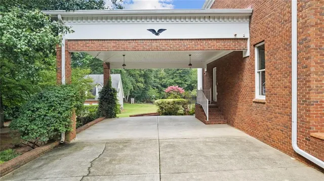 a bathroom with a granite countertop sink a mirror and shower