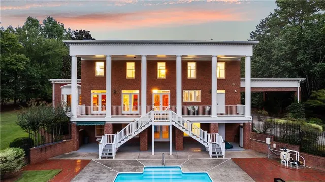 an aerial view of a house with yard swimming pool and outdoor seating