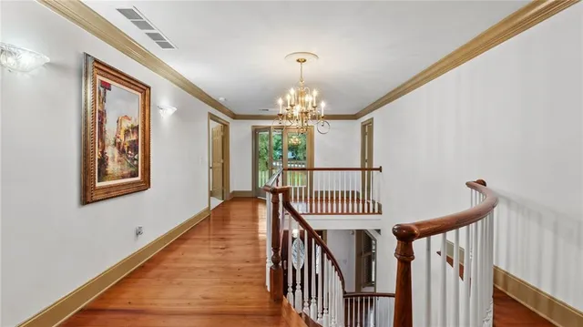 a room with furniture and a open kitchen view