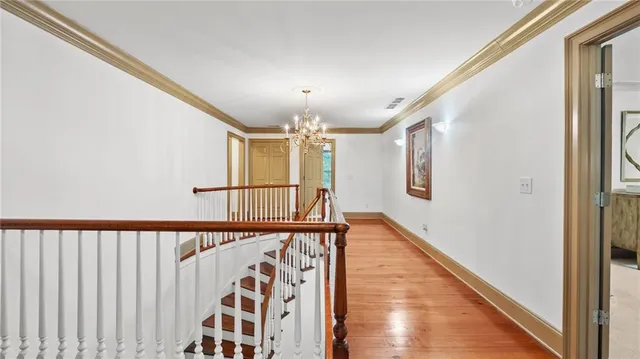 a view of a big room with windows and chandelier fan