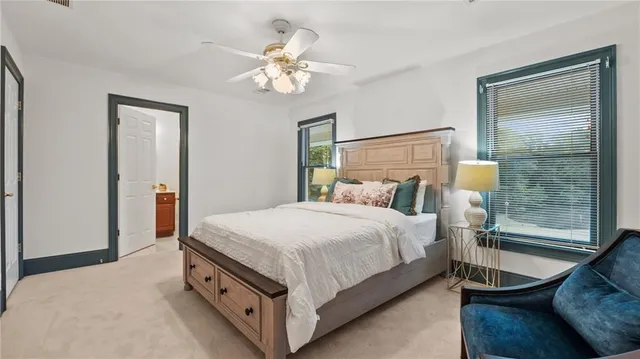 an aerial view of residential houses with outdoor space and trees