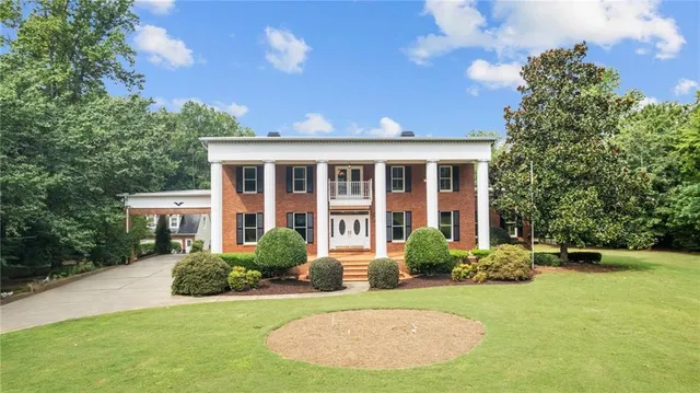 a view of a dining room with furniture wooden floor and a chandelier
