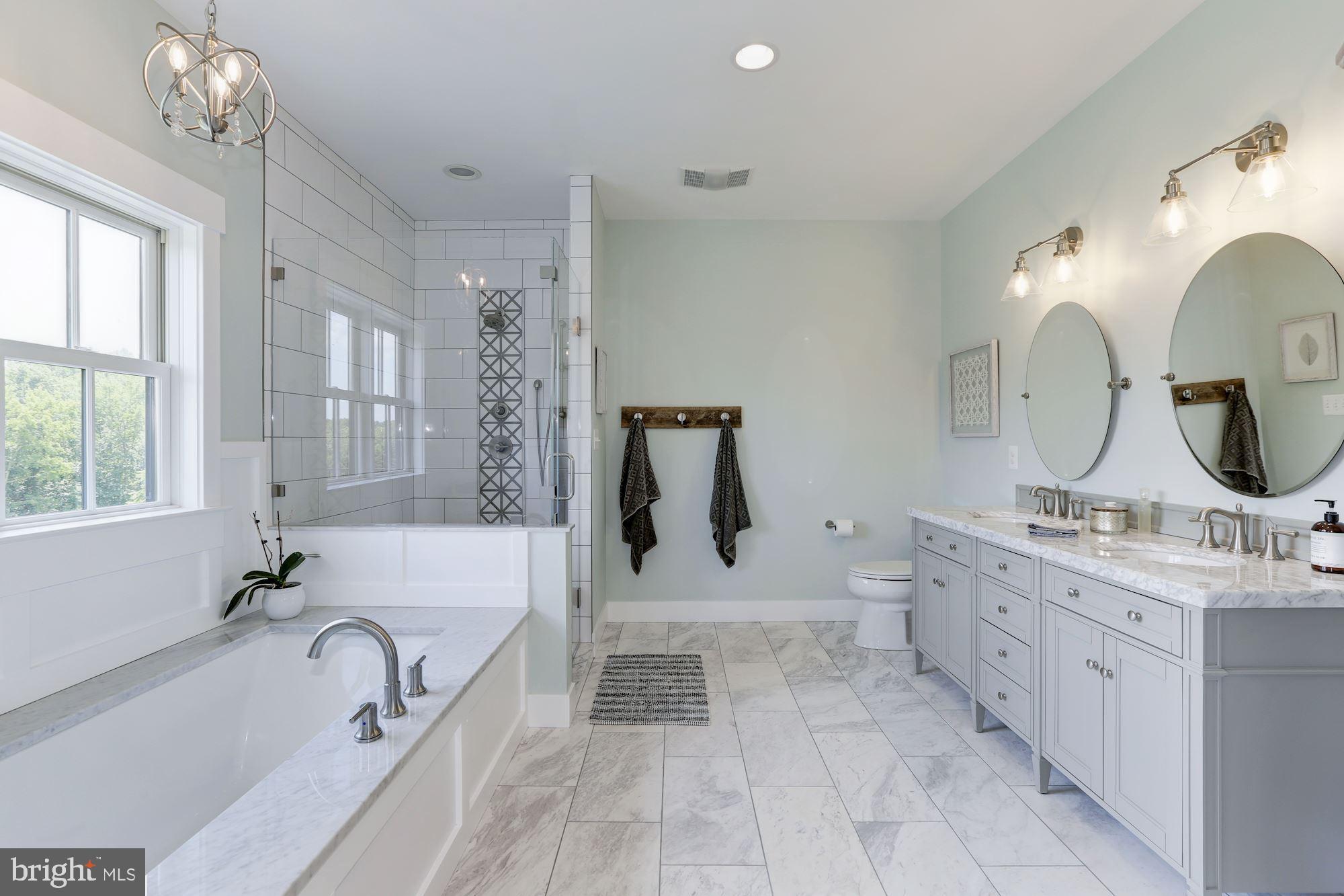 254 Friendship Road Tracys Landing, MD 20779 - Photo 16 of 21 a spacious bathroom with a double vanity sink a mirror a bathtub and shower