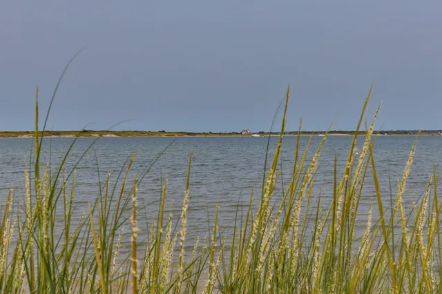a bathroom with a tub a sink and a large mirror