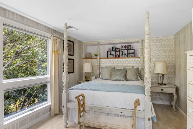 a bedroom with furniture and a window