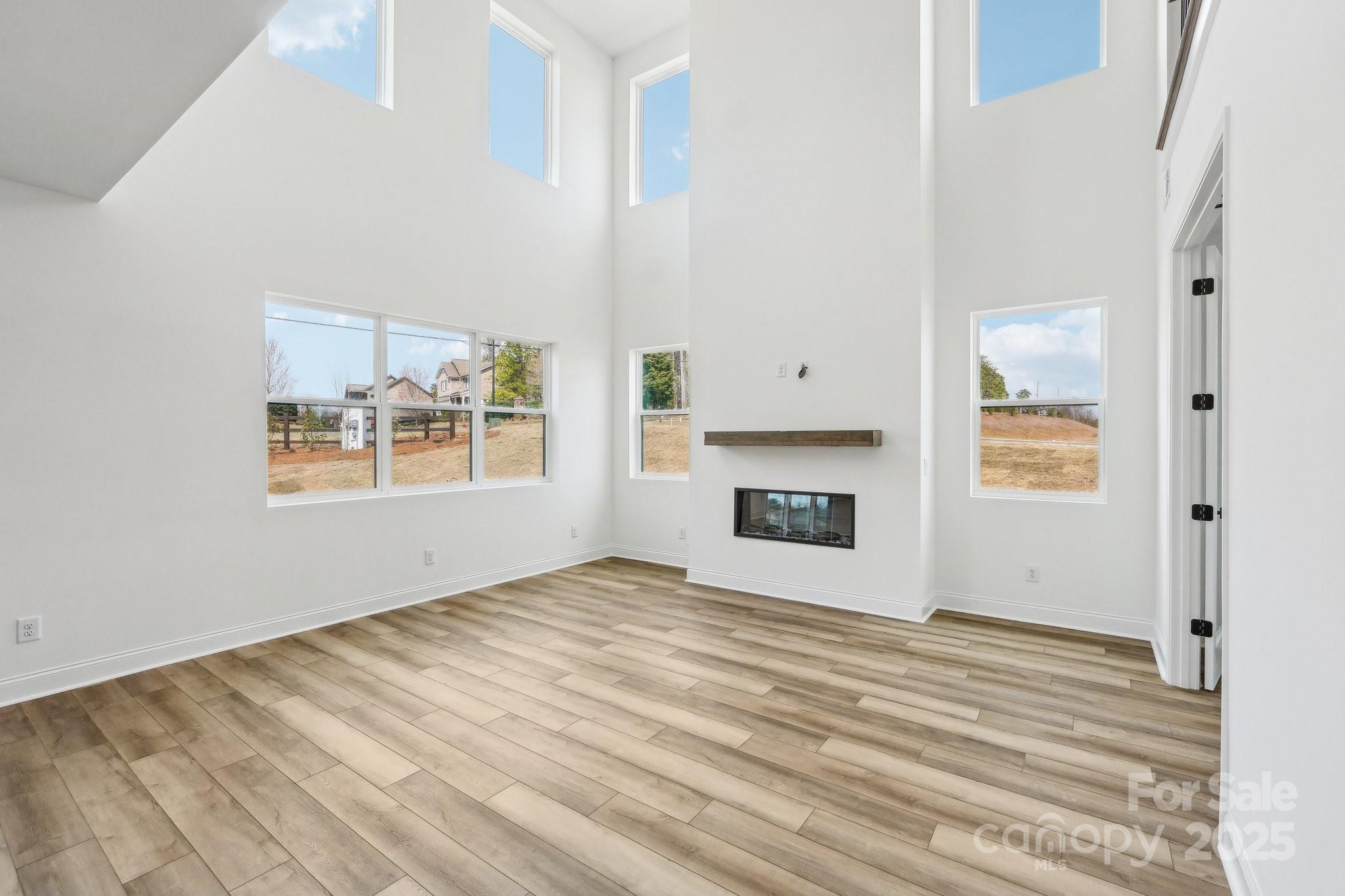 604 Hyder Trail Tega Cay, SC 29708 - Photo 15 of 44 a view of an empty room with window and fire place