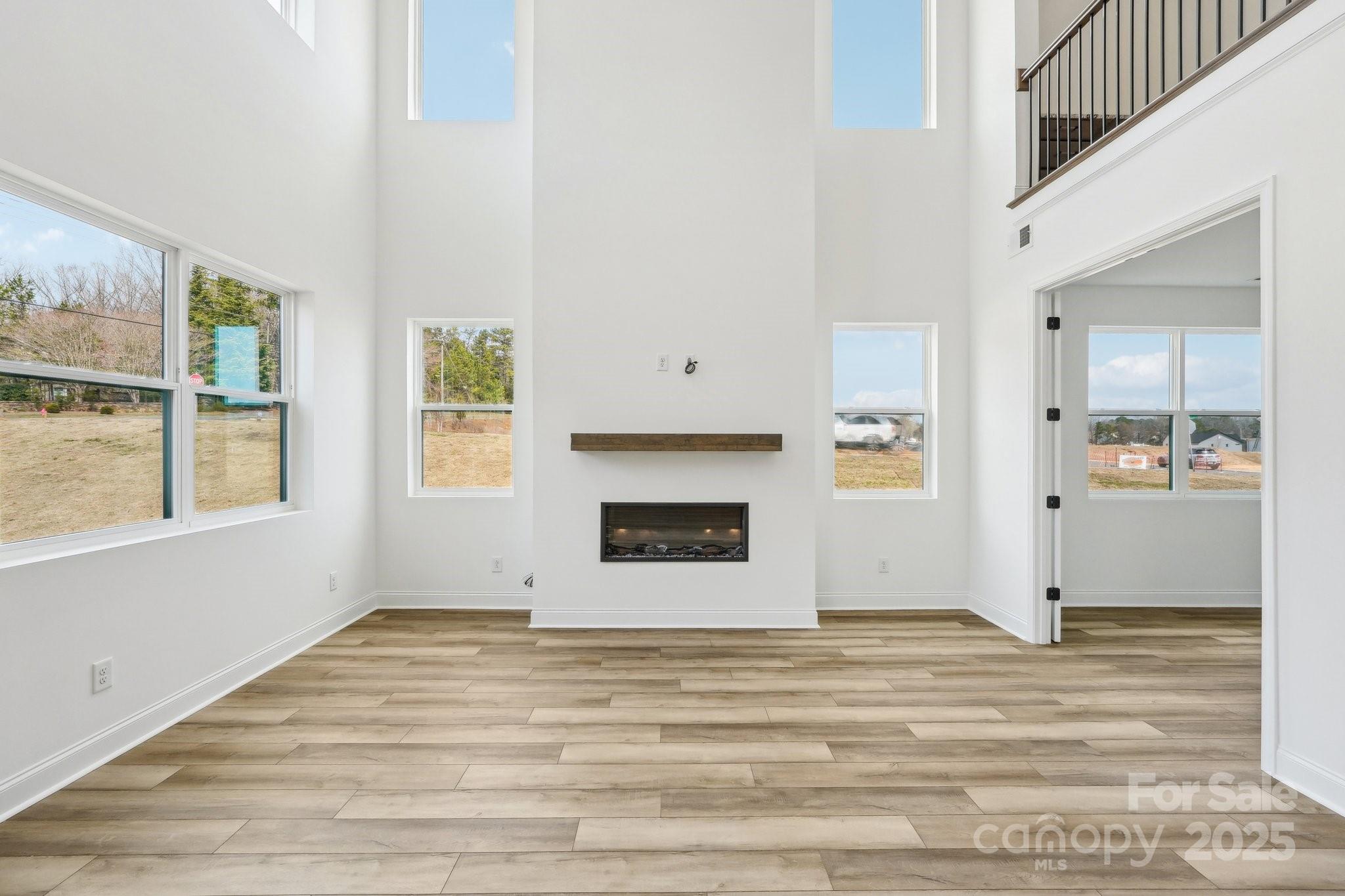 604 Hyder Trail Tega Cay, SC 29708 - Photo 17 of 44 a view of a livingroom with wooden floor and a fireplace