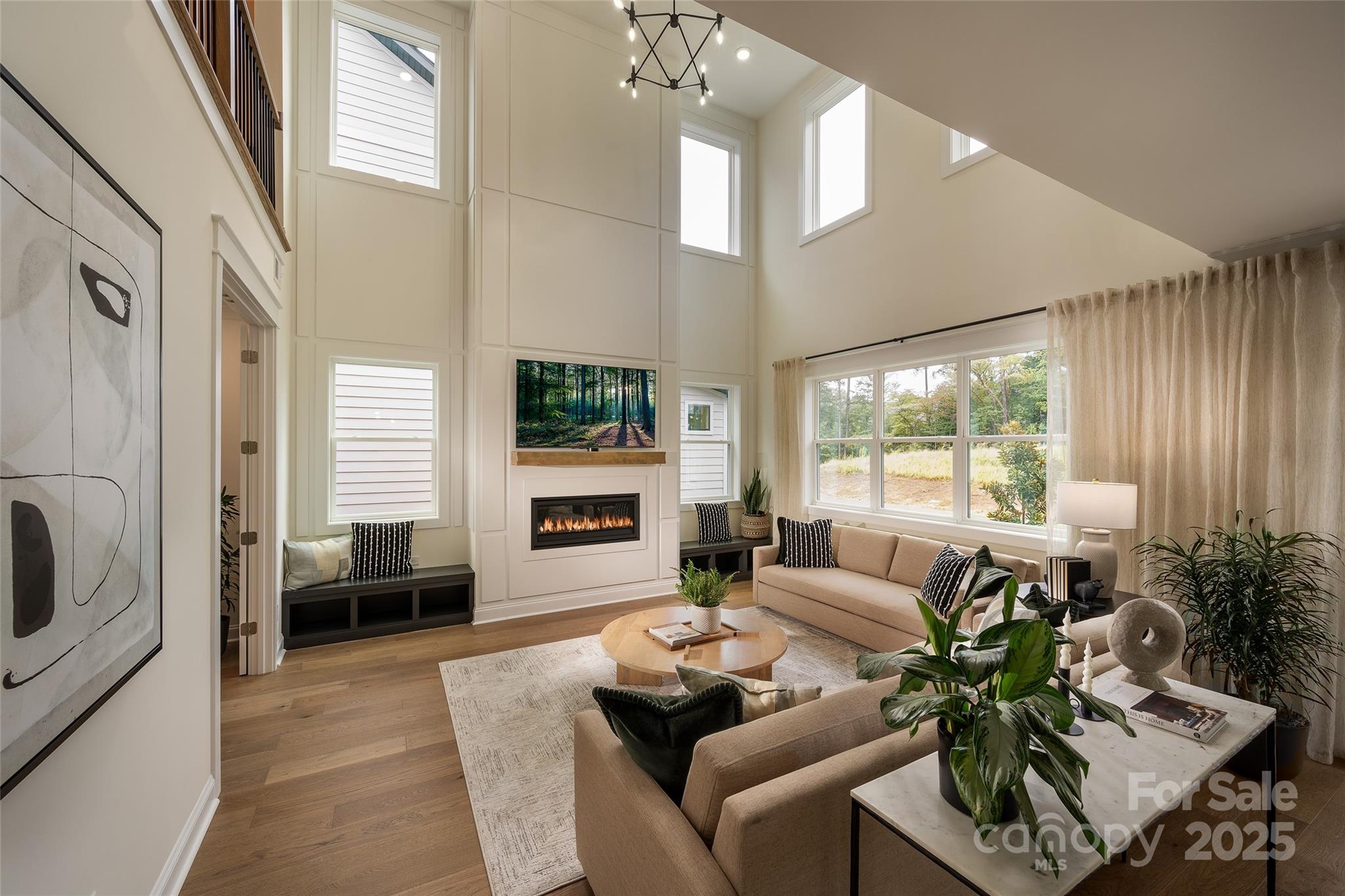 604 Hyder Trail Tega Cay, SC 29708 - Photo 18 of 44 a living room with furniture a large window and a chandelier