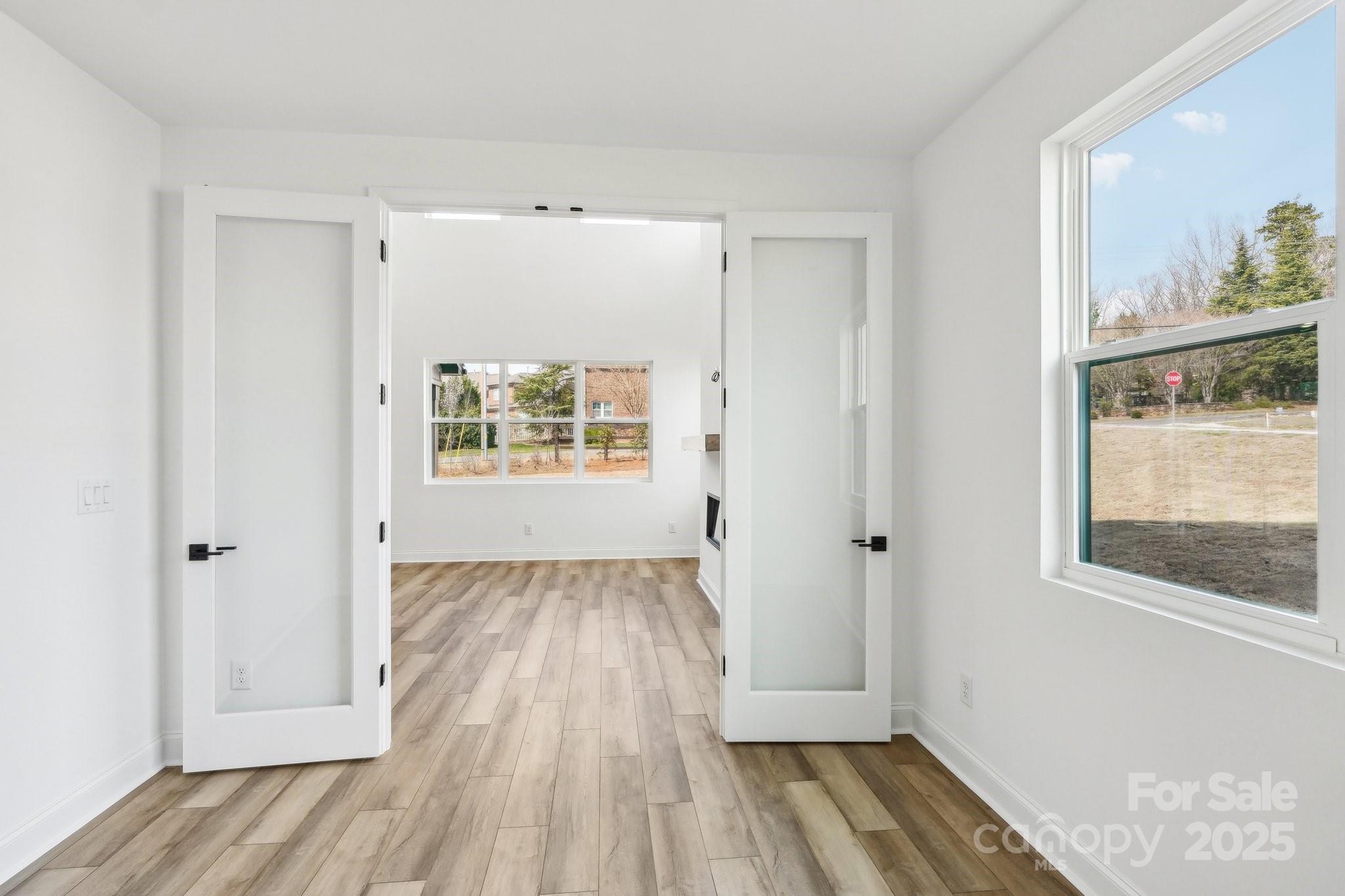 604 Hyder Trail Tega Cay, SC 29708 - Photo 20 of 44 a view of an empty room with wooden floor and a window