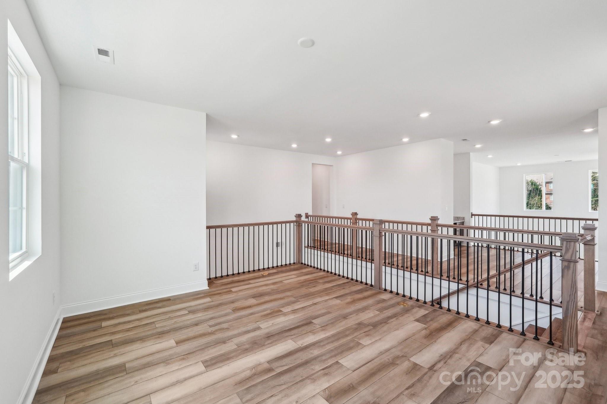 604 Hyder Trail Tega Cay, SC 29708 - Photo 24 of 44 a view of a hall with wooden floor