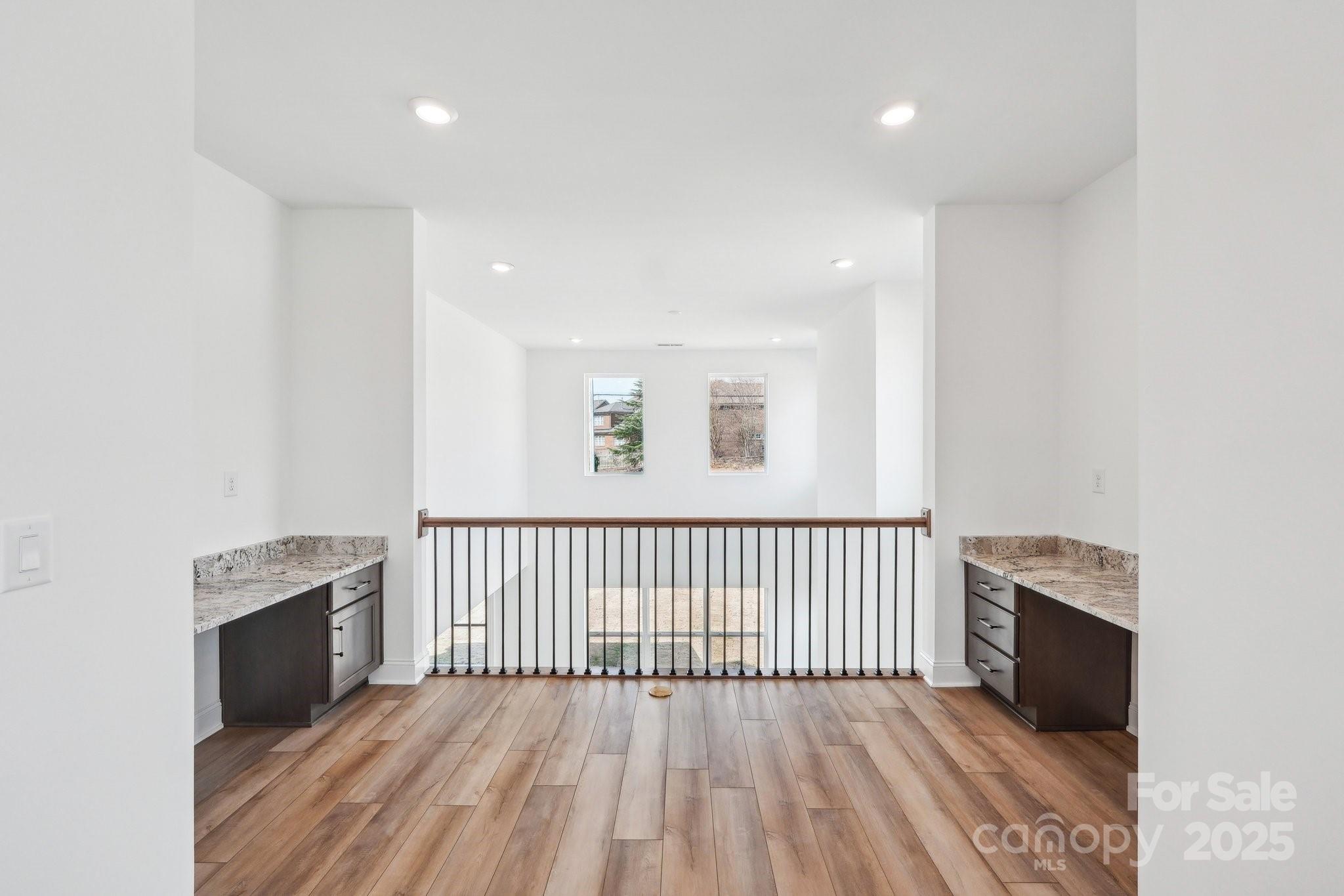604 Hyder Trail Tega Cay, SC 29708 - Photo 27 of 44 a view of a hallway with wooden floor and staircase