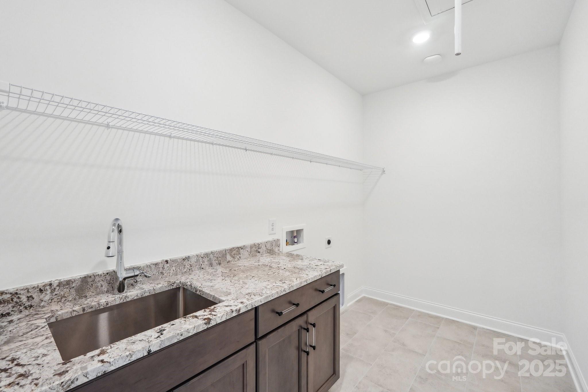 604 Hyder Trail Tega Cay, SC 29708 - Photo 29 of 44 a kitchen with a sink and cabinets