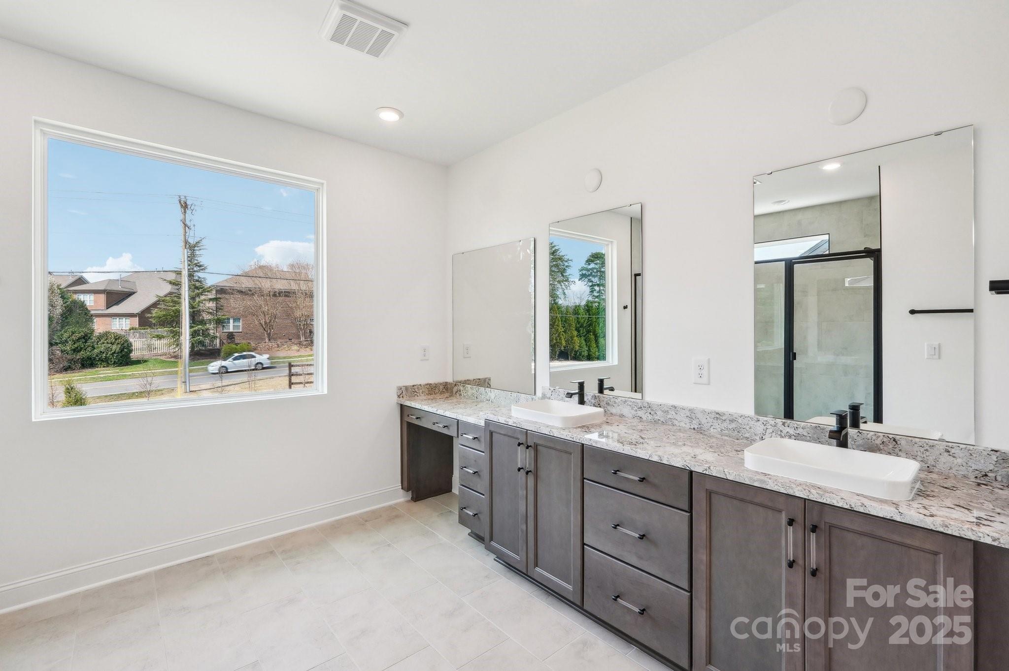 604 Hyder Trail Tega Cay, SC 29708 - Photo 32 of 44 a bathroom with a granite countertop sink mirror and window
