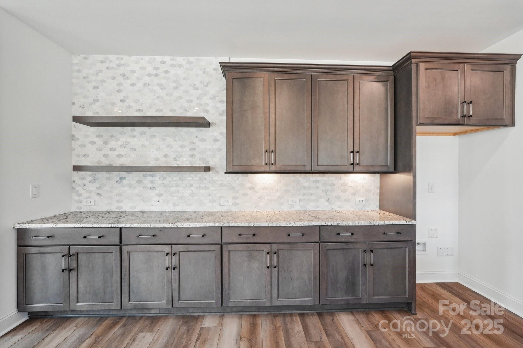 604 Hyder Trail Tega Cay, SC 29708 - Photo 6 of 44 a kitchen with granite countertop white cabinets and sink