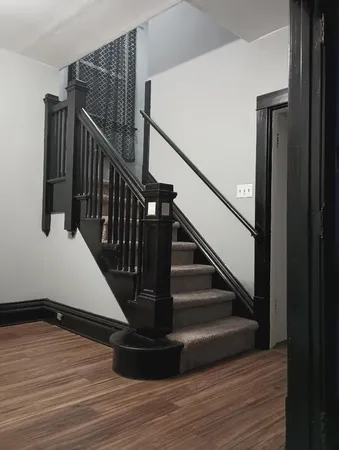 a view of entryway and hall with wooden floor