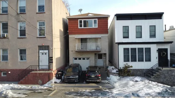 a front view of a house with many windows