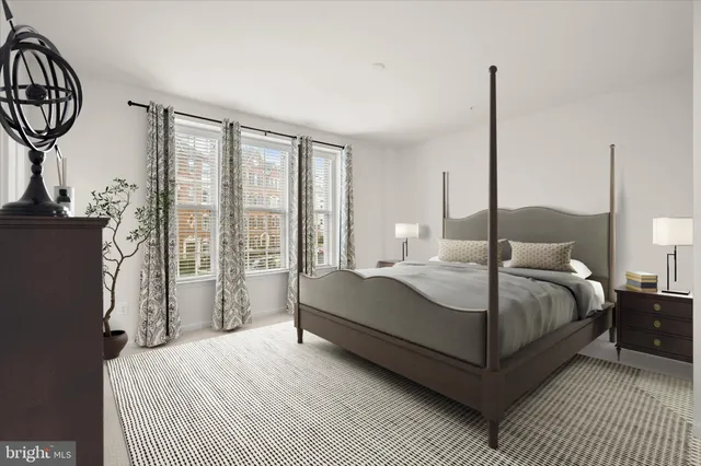 a bedroom with a bed a mirror and window