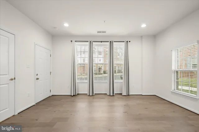 a view of a kitchen with a sink and dishwasher a refrigerator with wooden floor