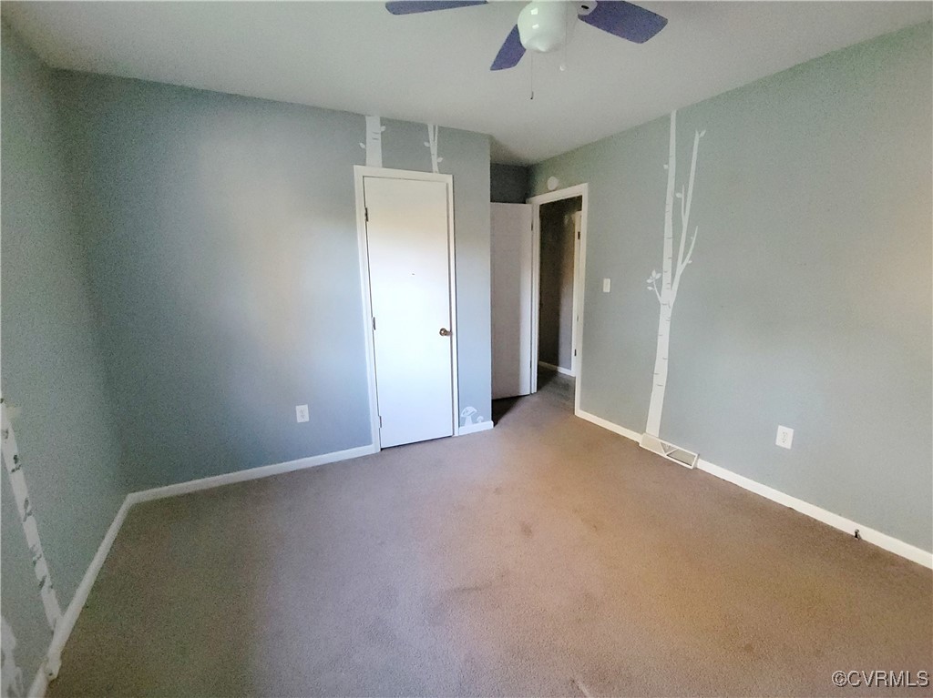 15604 Exter Mill Road Chesterfield, VA 23838 - Photo 19 of 22 an empty room with a ceiling fan and a window