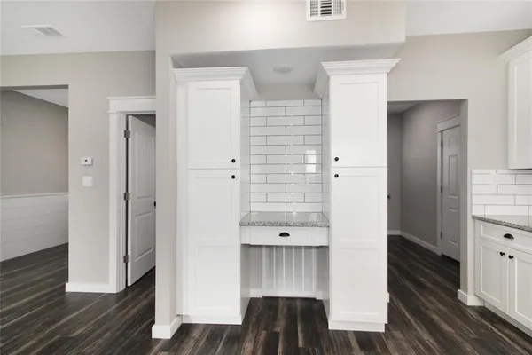 a view of a hallway with wooden floor and closet