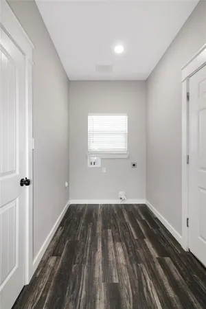 a view of a room with wooden floor and window