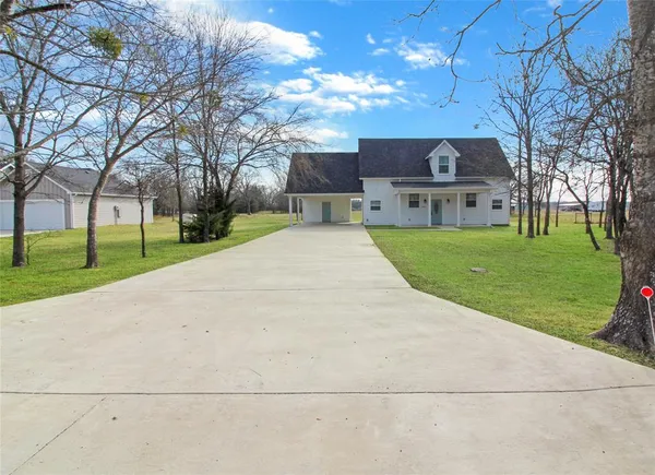 a front view of house with yard and green space