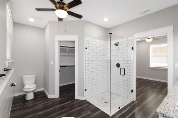 a bathroom with a shower sink and toilet