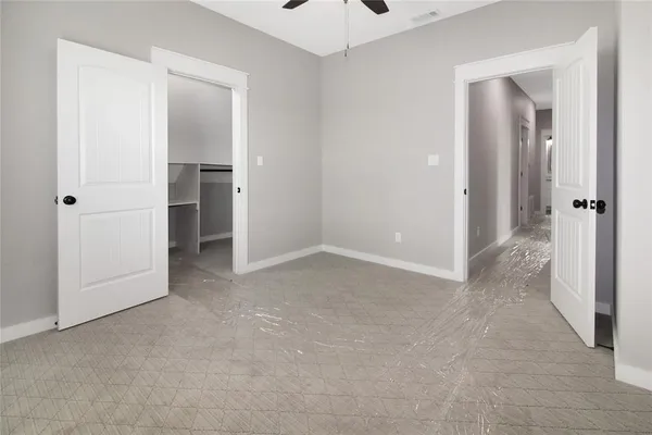 an empty room with closet and a hallway