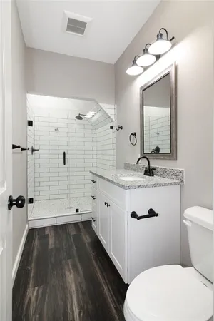 a bathroom with a sink a toilet a mirror and vanity