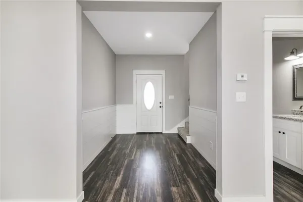 a view of a room with wooden floor and a bathroom
