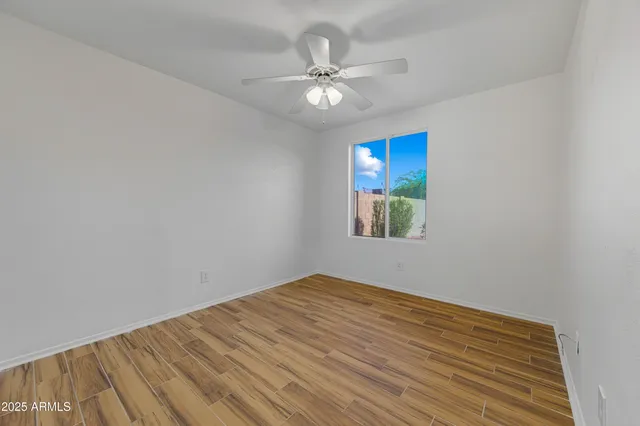a bathroom with a granite countertop sink mirror vanity and toilet