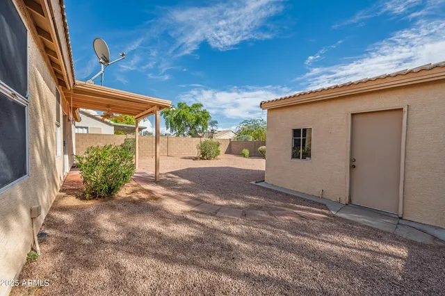a backyard of a house with a tree