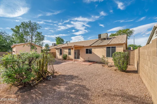 front view of a house with a yard and a garage