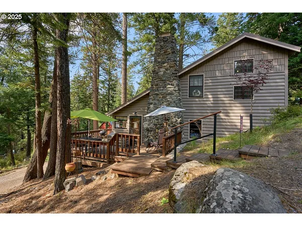 a view of a house with backyard and chairs