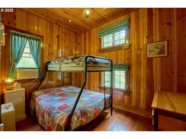 a bedroom with a bed window and a mirror