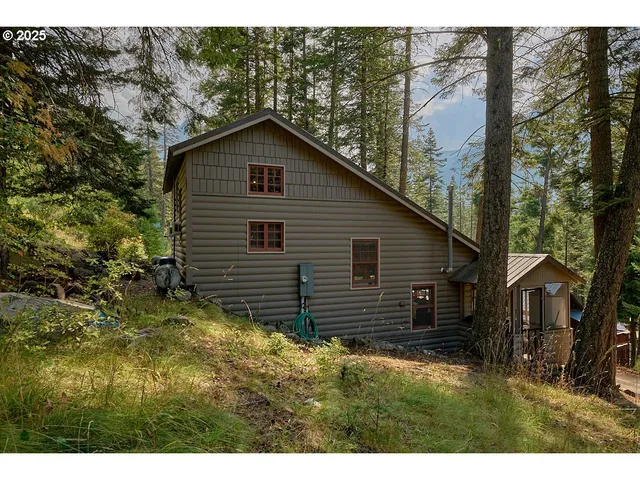 a backyard of a house with large trees and brick walls