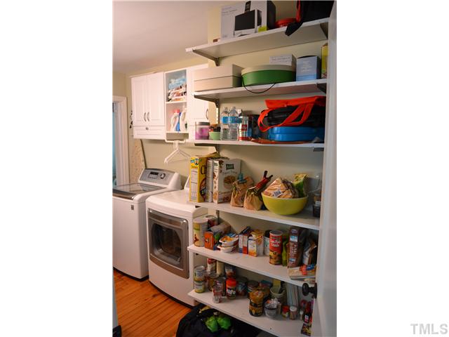 309 Glascock Street Raleigh, NC 27604 - Photo 17 of 23 a view of washer and dryer with racks on the wall