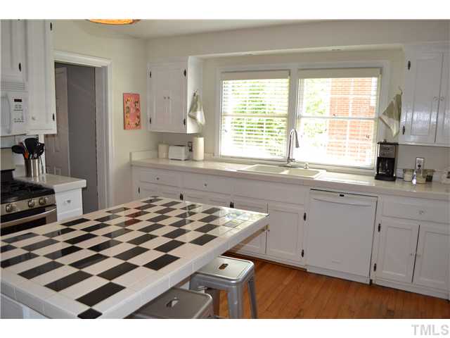 309 Glascock Street Raleigh, NC 27604 - Photo 9 of 23 a kitchen that has a sink and a stove