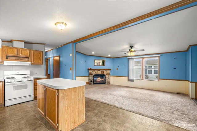 a view of a kitchen with a sink and refrigerator