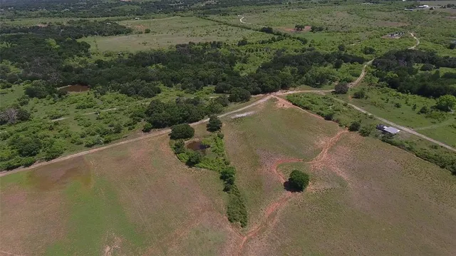 an aerial view of a houses with a yard