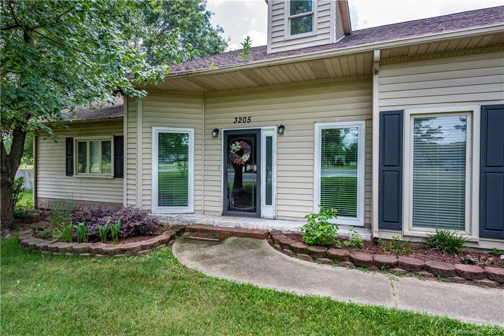 3205 Old Camden Road Monroe, NC 28110 - Photo 3 of 48 a front view of a house with a yard and potted plants