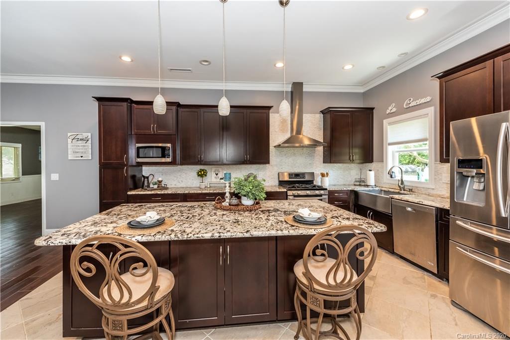 3205 Old Camden Road Monroe, NC 28110 - Photo 8 of 48 a kitchen with stainless steel appliances granite countertop a stove a sink and a microwave